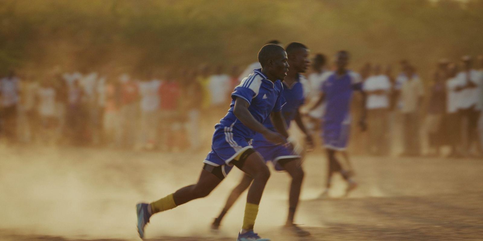 A player sprints through dust during a match